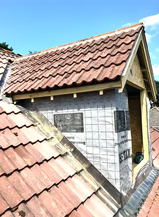 Tiled dormer extension being built